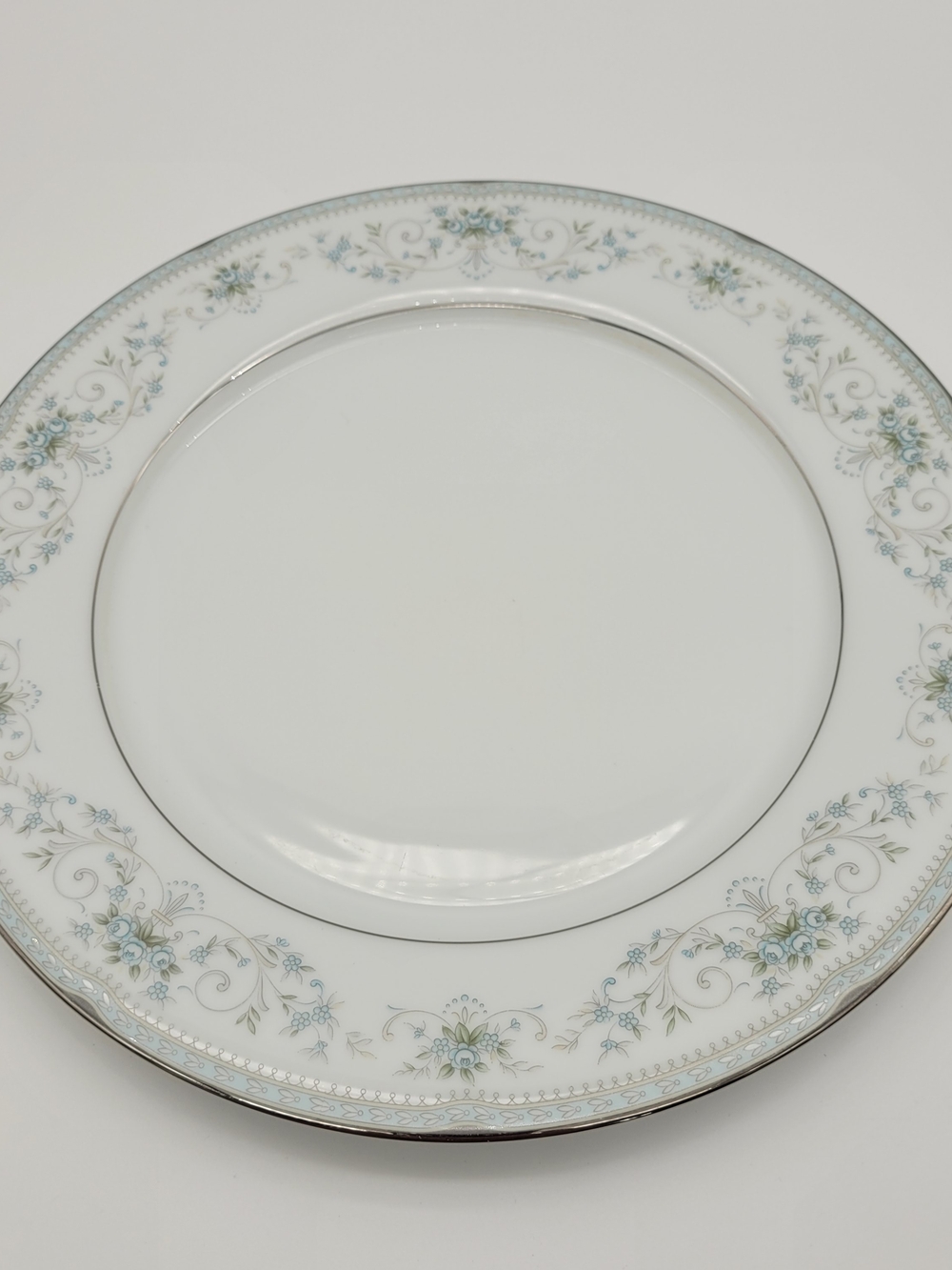 Noritake 6107 White Dinner Plate with Pale Blue Floral Border and Silver Trim